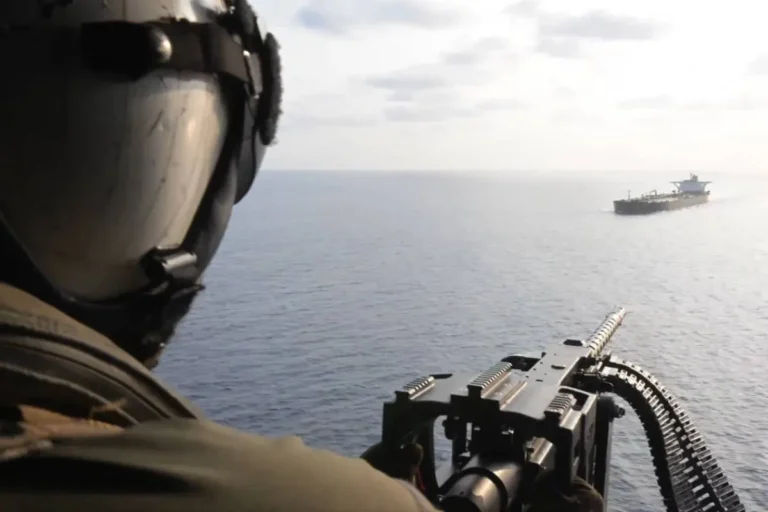 US naval forces intercepting cargo ship near Iranian waters during escalating maritime conflict