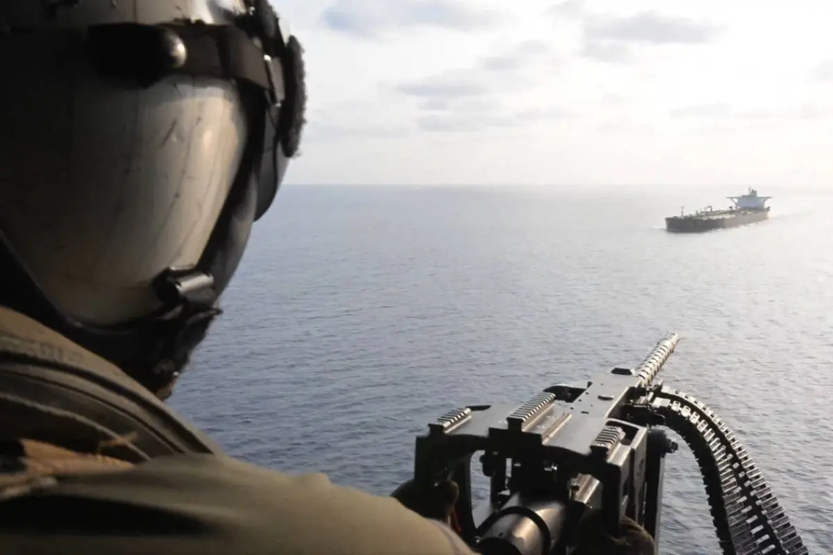 US naval forces intercepting cargo ship near Iranian waters during escalating maritime conflict