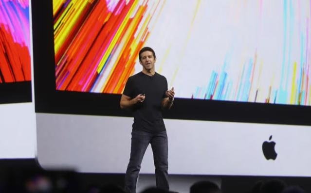 John Ternus presenting Apple products during a company event showcasing new technology developments