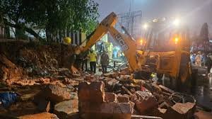 Wall collapse in Bengaluru during heavy rain causing casualties and emergency response at site