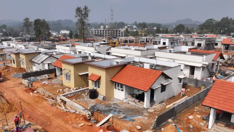 Wayanad Township housing project showing residential buildings under construction with minor roof crack inspection*