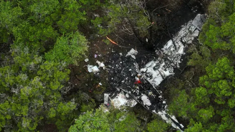 Wreckage of small plane after crash in Texas forest area with emergency response teams