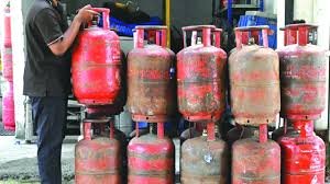 Commercial LPG gas cylinders stacked outside a restaurant kitchen